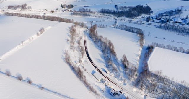 Snowy Landscape with a Road Crossing