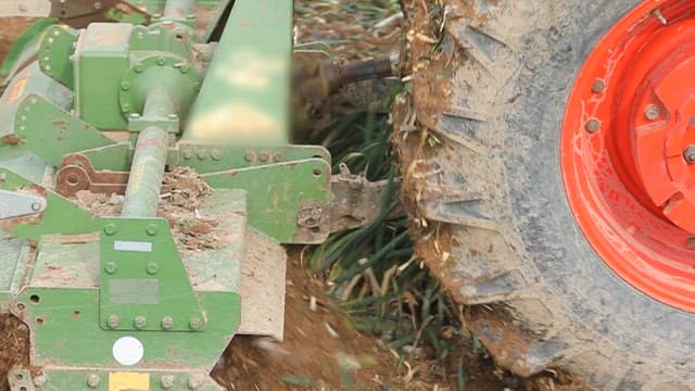Tractor plowing through a field