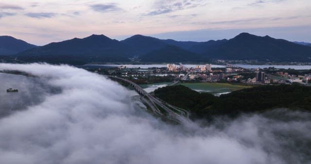 Cityscape with mountains and clouds
