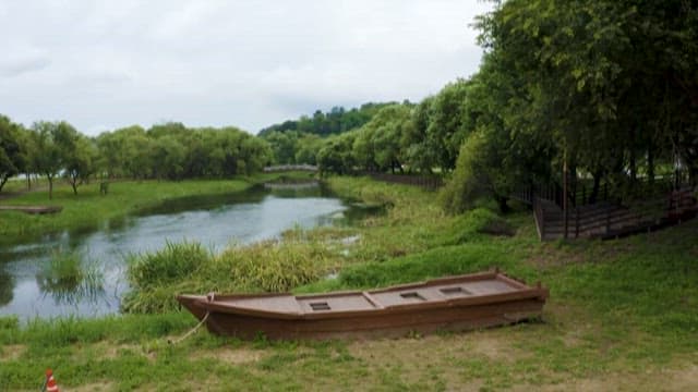 Serene Lakeside Landscape with Traditional Boat