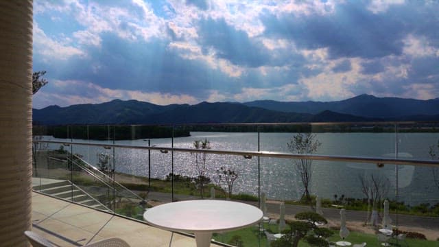 Riverside with sunlight shining through clouds