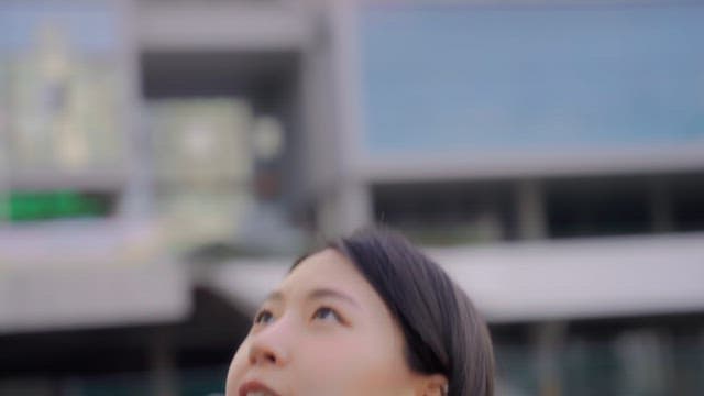 Woman smiling while playing basketball