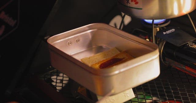 Preparing a snack on a portable stove