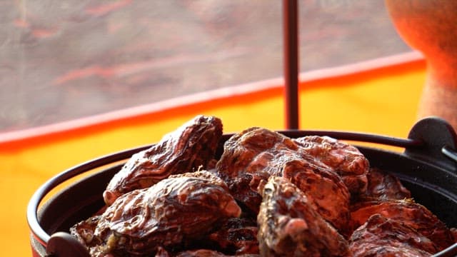 Fresh oysters prepared in a pot on a gas stove