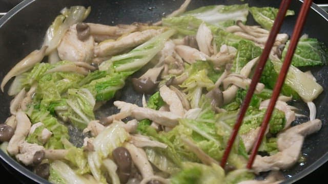Mushrooms and cabbage stir-fried in a hot oiled frying pan