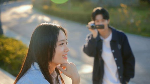 Couple filming a video with a camcorder in the park