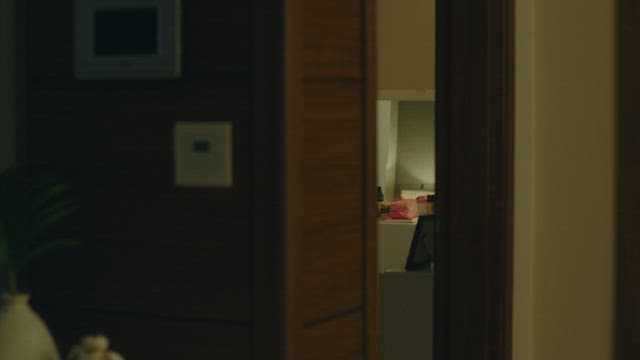 A dimly lit room viewed through an open door