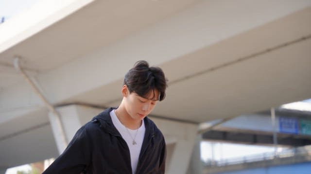 Man skipping rope under a bridge