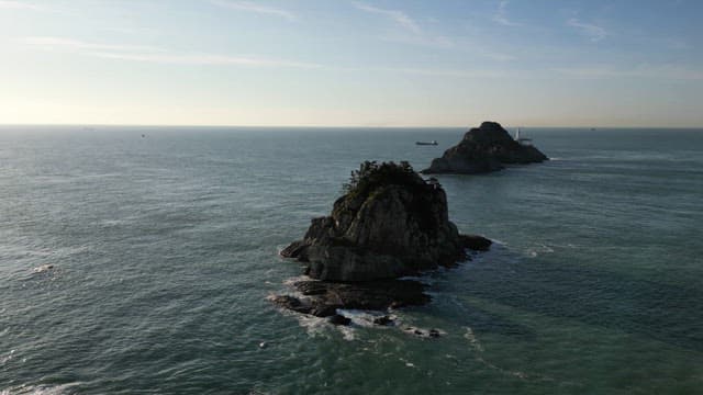 Rocky islands with a distant lighthouse