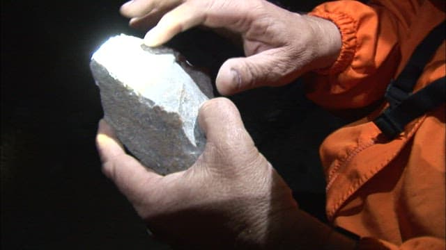 Examining a rock sample in the dark