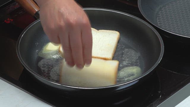 Cooking toast as a breakfast with bread and butter in a pan