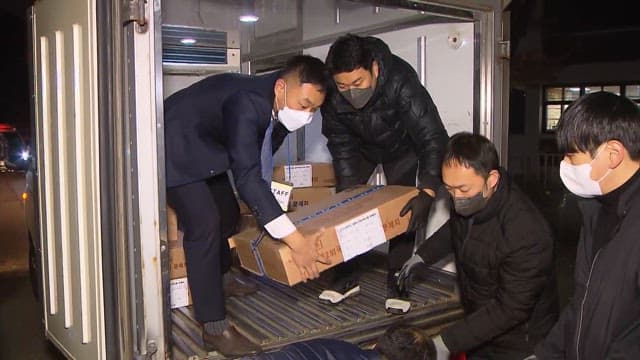 Workers Transporting Boxes Containing CSAT Test Papers at Night