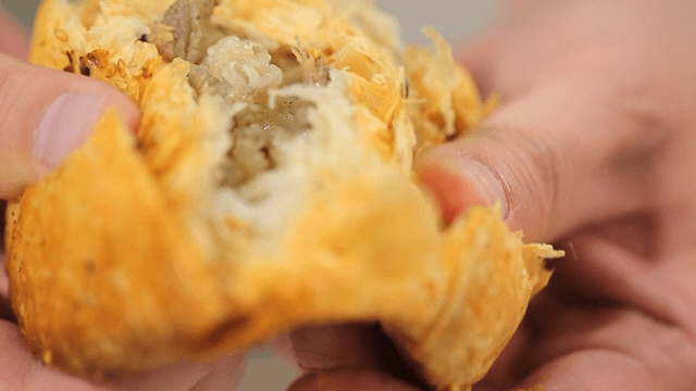 Hands breaking open a Russian meat dumplings, Camca