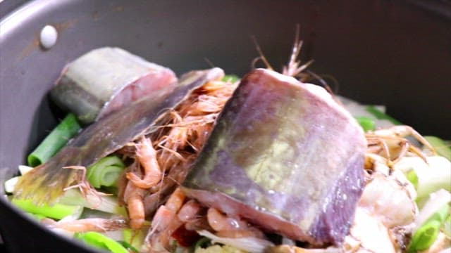 Spicy Stew with Fresh Fish and Vegetables Being Cooked in a Kitchen