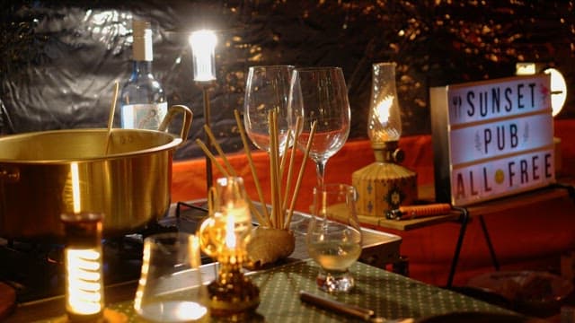 Cozy indoor dining setup with drinks and lights of lantern