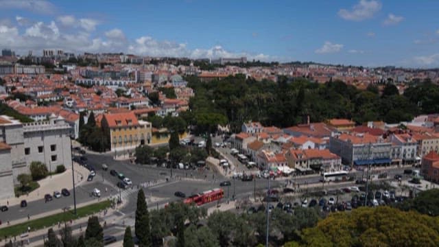 Town with Red Rooftops and Roads Under a Blue Sky