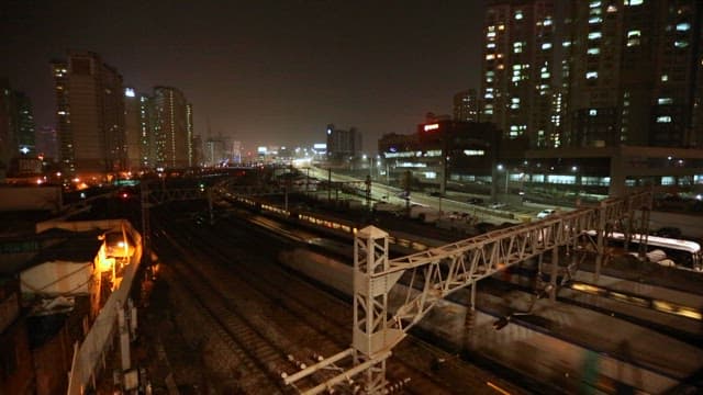 Night view of cityscape with moving trains
