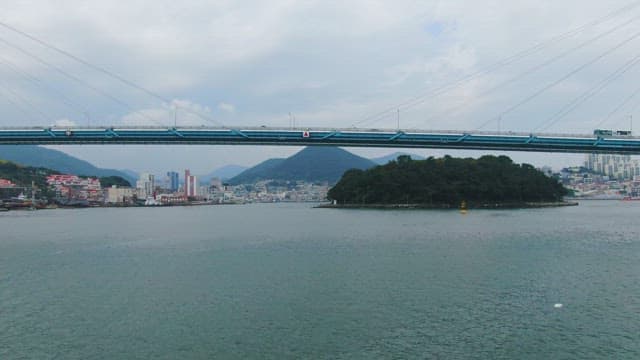 Bridge over a sea with cityscape