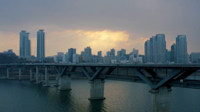 Sunset over the bustling cityscape and bridge