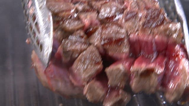 Juicy grilled steak on a hot grill