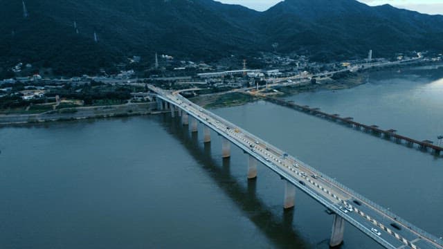 A bridge over a river with moving cars
