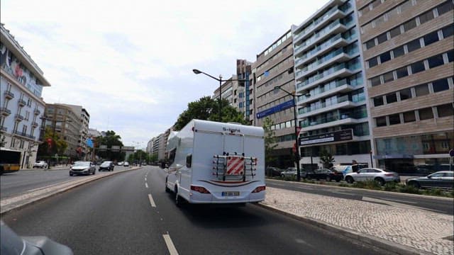 Camper van traveling on a road with cars