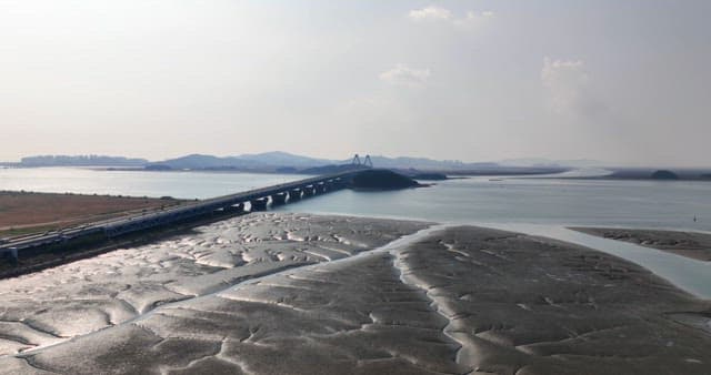 Long bridge over a serene coastal area