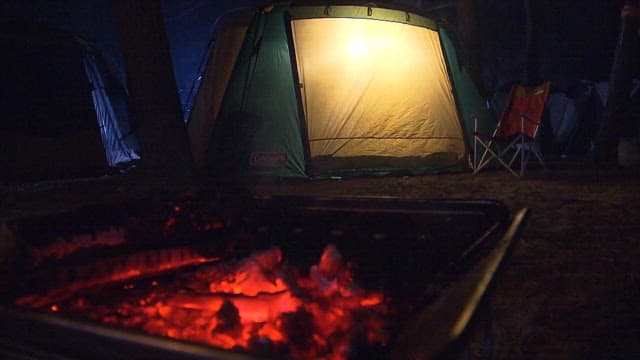 Glowing Tent and Campfire at Night