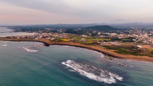 Coastal city with mountains in the distance