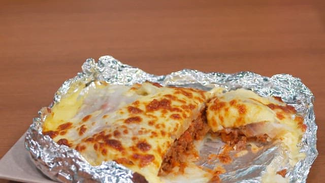 Cheese-covered Chou Farci with beef in aluminum foil