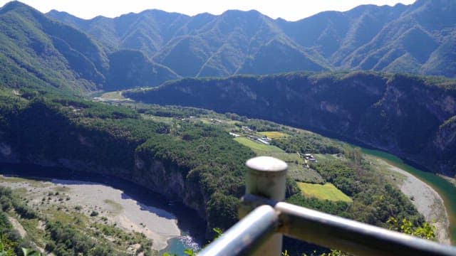 Scenic view of mountains and a river from a high vantage point during daylight