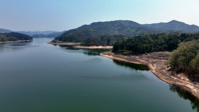 Tranquil lake surrounded by lush mountains