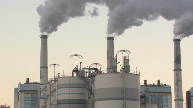 Industrial Plant Emitting Smoke at Dusk