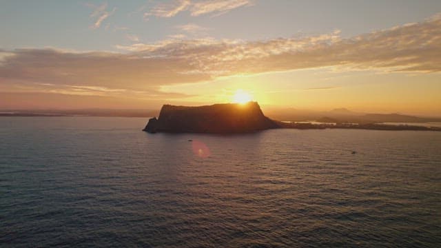 Sunset over the ocean with distant islands