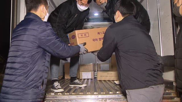 Workers Transporting Boxes Containing CSAT Test Papers at Night