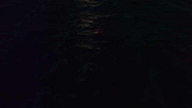 Aerial View of a Ship Sailing at Night