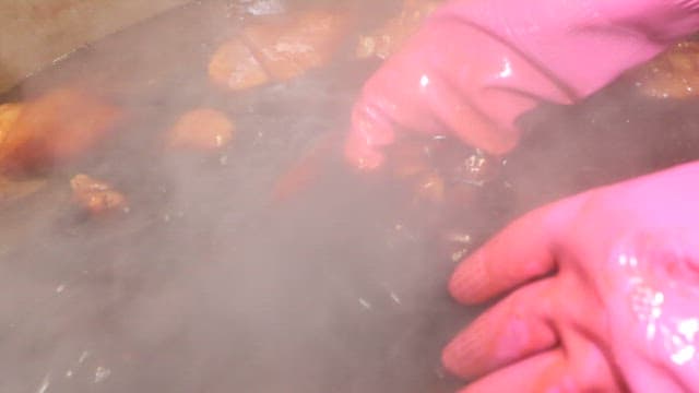Pig's feet cooked in a large cauldron