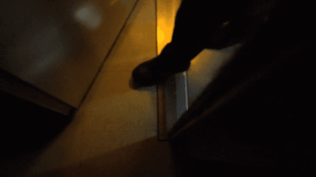 Person Entering an Office in a Dark Building