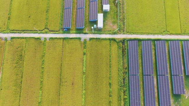 Solar panels in a vast green field