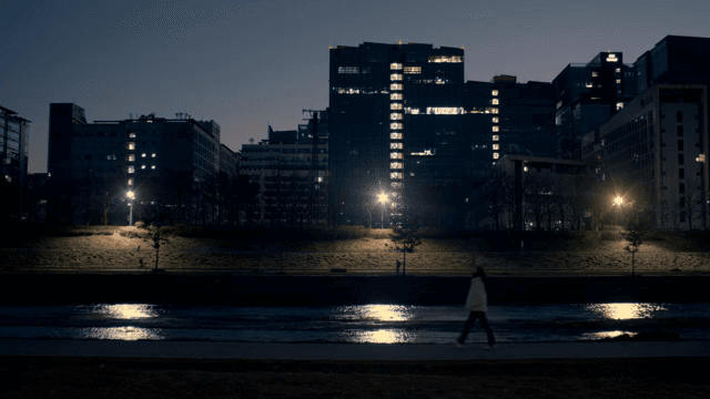 Night view of a city with buildings and river