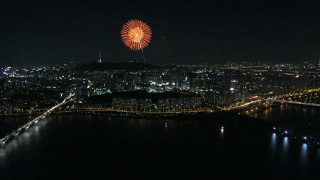 Nighttime Cityscape with Fireworks Display