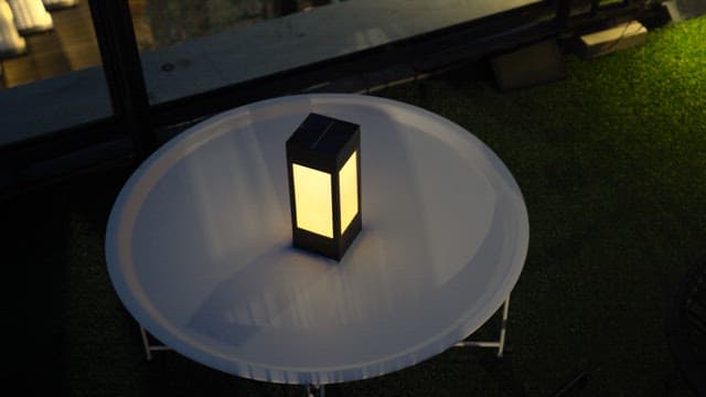 Glowing lantern on a rooftop at dusk