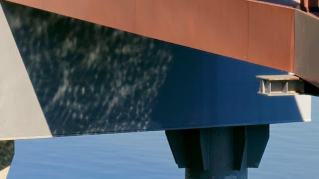 Metal structure reflecting the rippling water surface