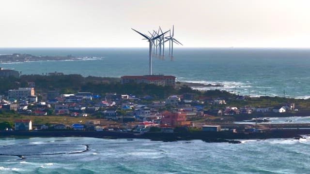 Coastal town with wind turbines and ocean