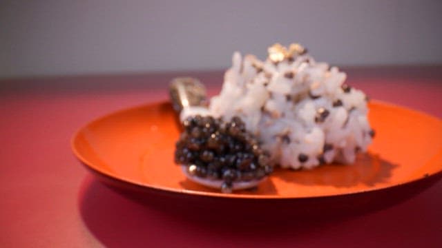 Gourmet dish with caviar on a red plate