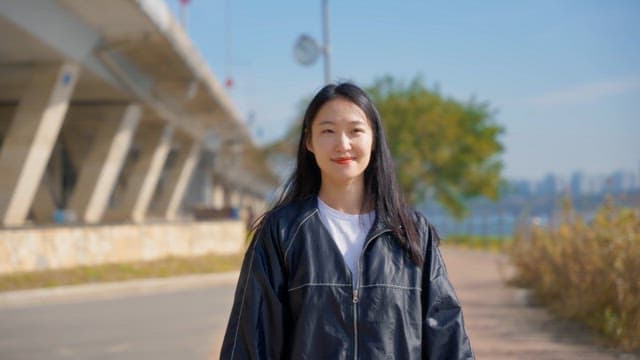 Woman walking outdoors with earphones