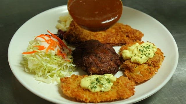 Plate of assorted pork cutlets and salad