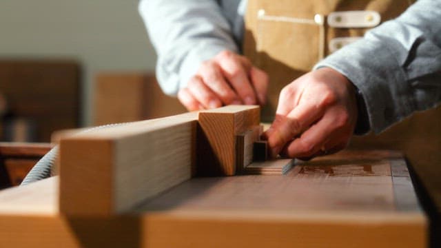 Craftsman Precisely Assembling Wooden Pieces