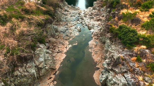Kayakers on a scenic river surrounded by rocky cliffs
