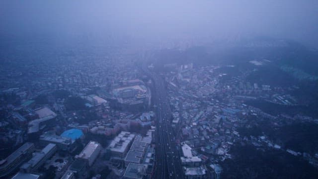 Dense Cityscape in Foggy Weather at twilight